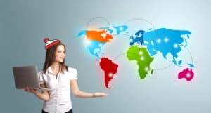 Young woman holding a laptop and presenting colorful world map